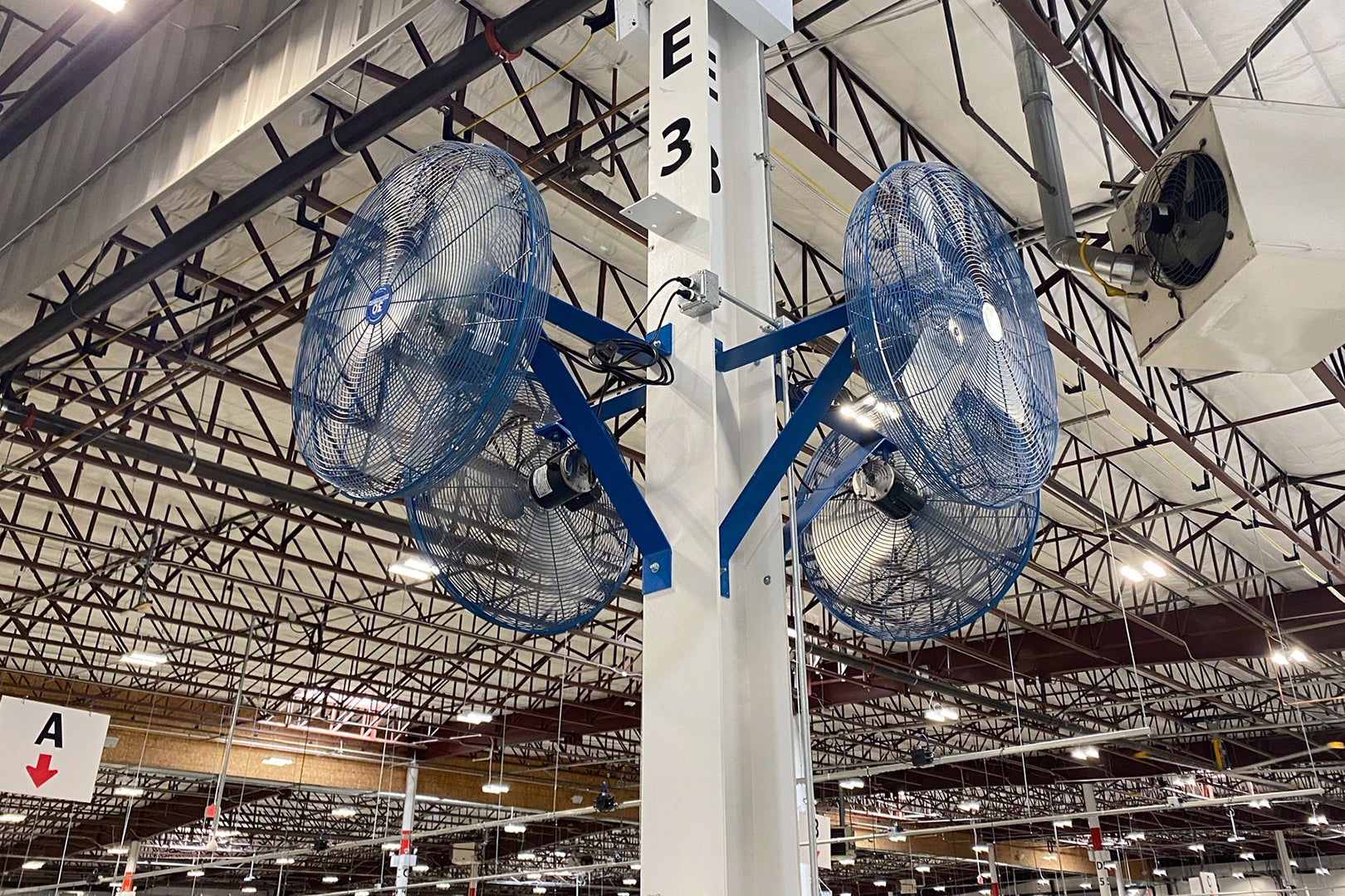 Dual Patterson industrial fans mounted on a warehouse column for high-volume airflow
