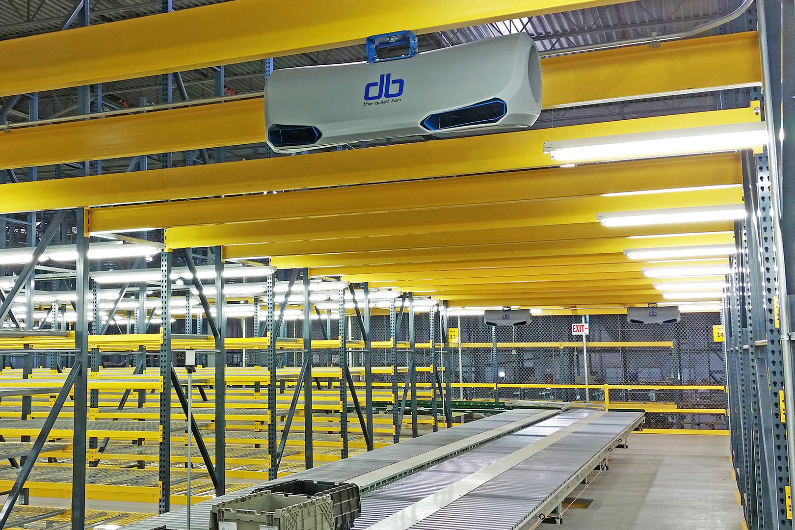 db quiet industrial fan mounted above warehouse conveyor system for improved airflow in storage racks