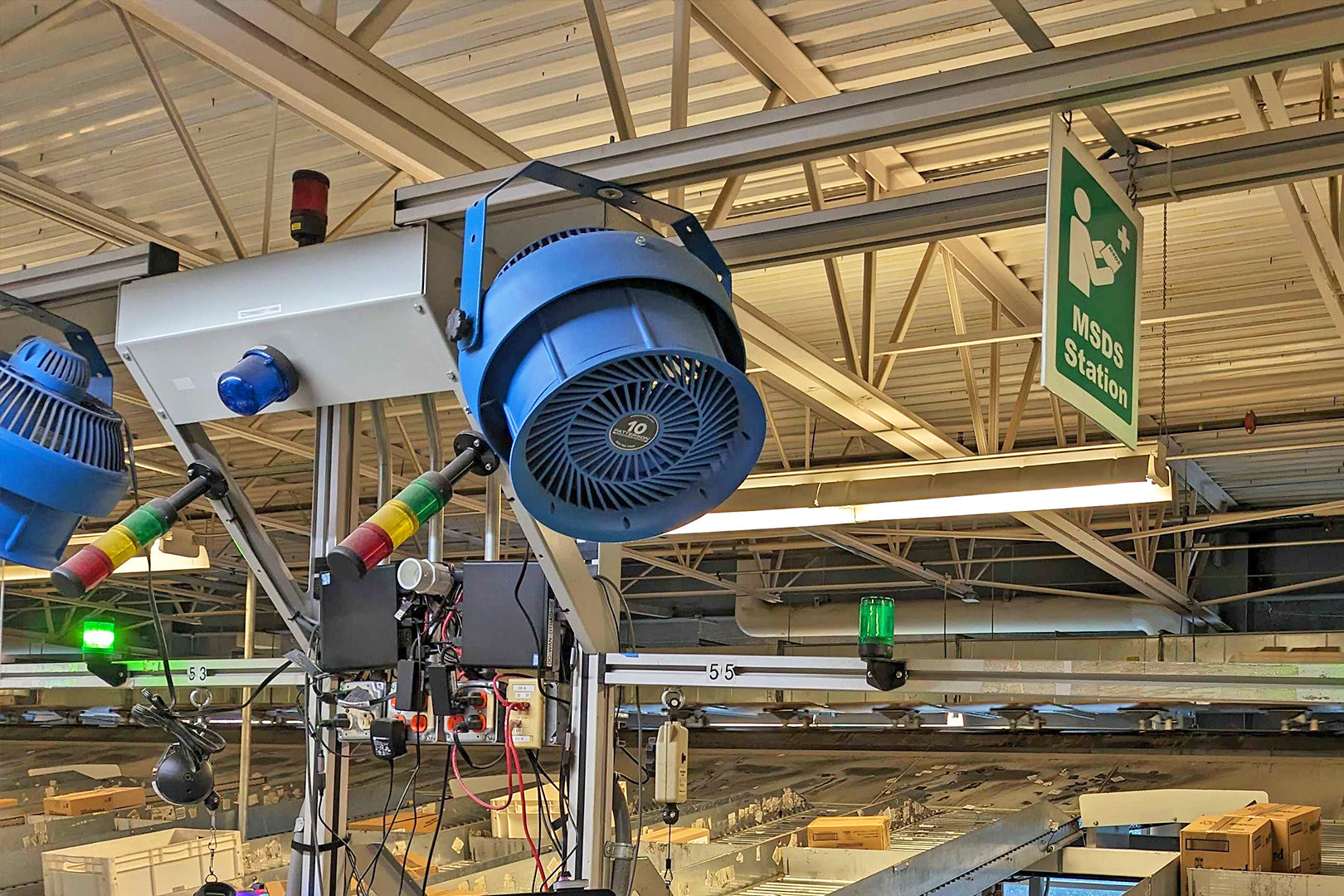 Patterson 10-inch industrial fans mounted on overhead beams in warehouse for high-velocity air circulation