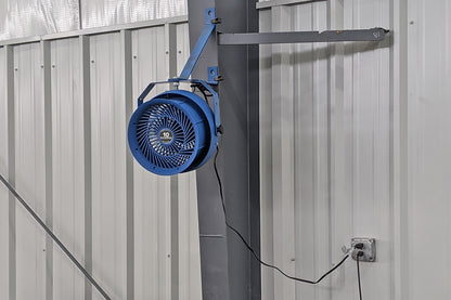 Wall-mounted Patterson 10-inch industrial fan installed on adjustable arm inside a metal building