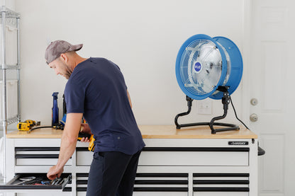Blue Air industrial portable fan on a workbench providing cooling in a garage workshop