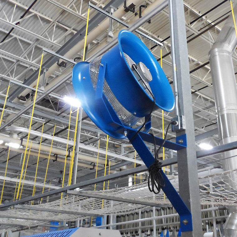 Blue industrial ventilation fan mounted on a support beam inside a warehouse