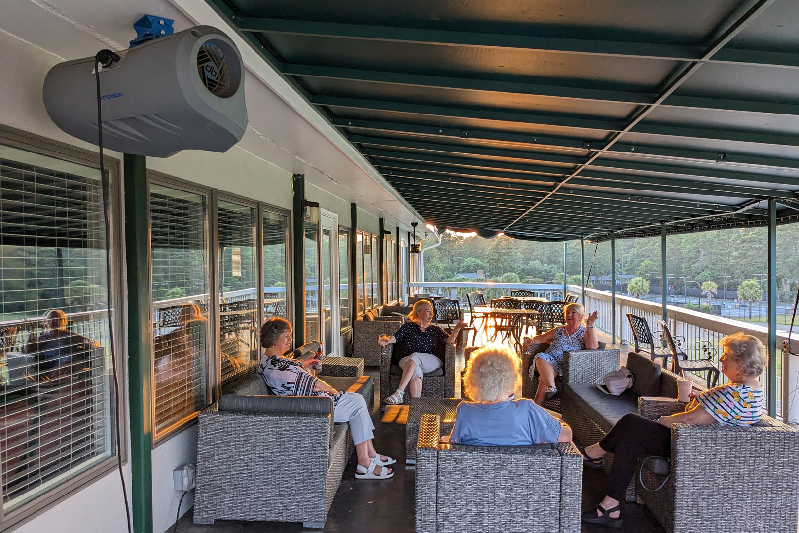 db quiet outdoor fan mounted on covered patio providing airflow for guests in an outdoor dining area