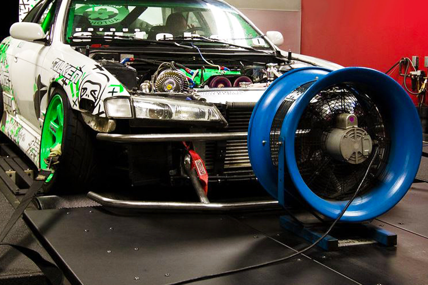 High-performance automotive fan providing airflow to a modified race car during engine testing on a dynamometer