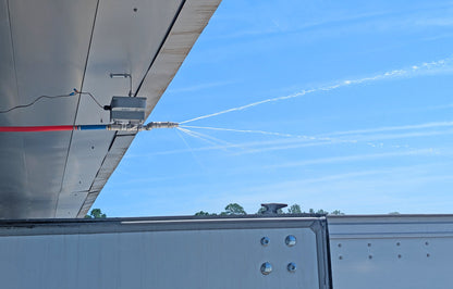 Spray evaporative truck cooler unit misting to reduce heat during loading operations
