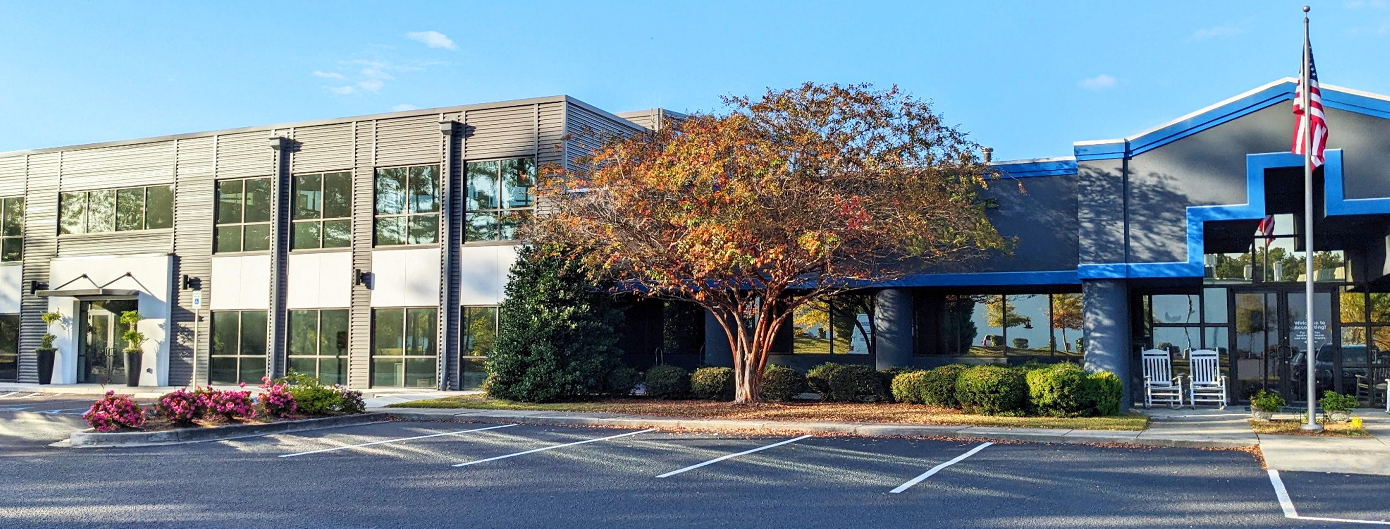 Patterson Fan Company building exterior with landscaped entrance and American flag on a sunny day