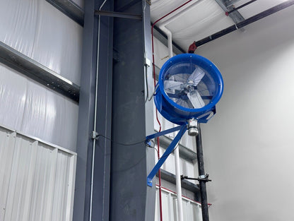 Mounted industrial blue high-velocity fan attached to steel support beam inside a warehouse facility