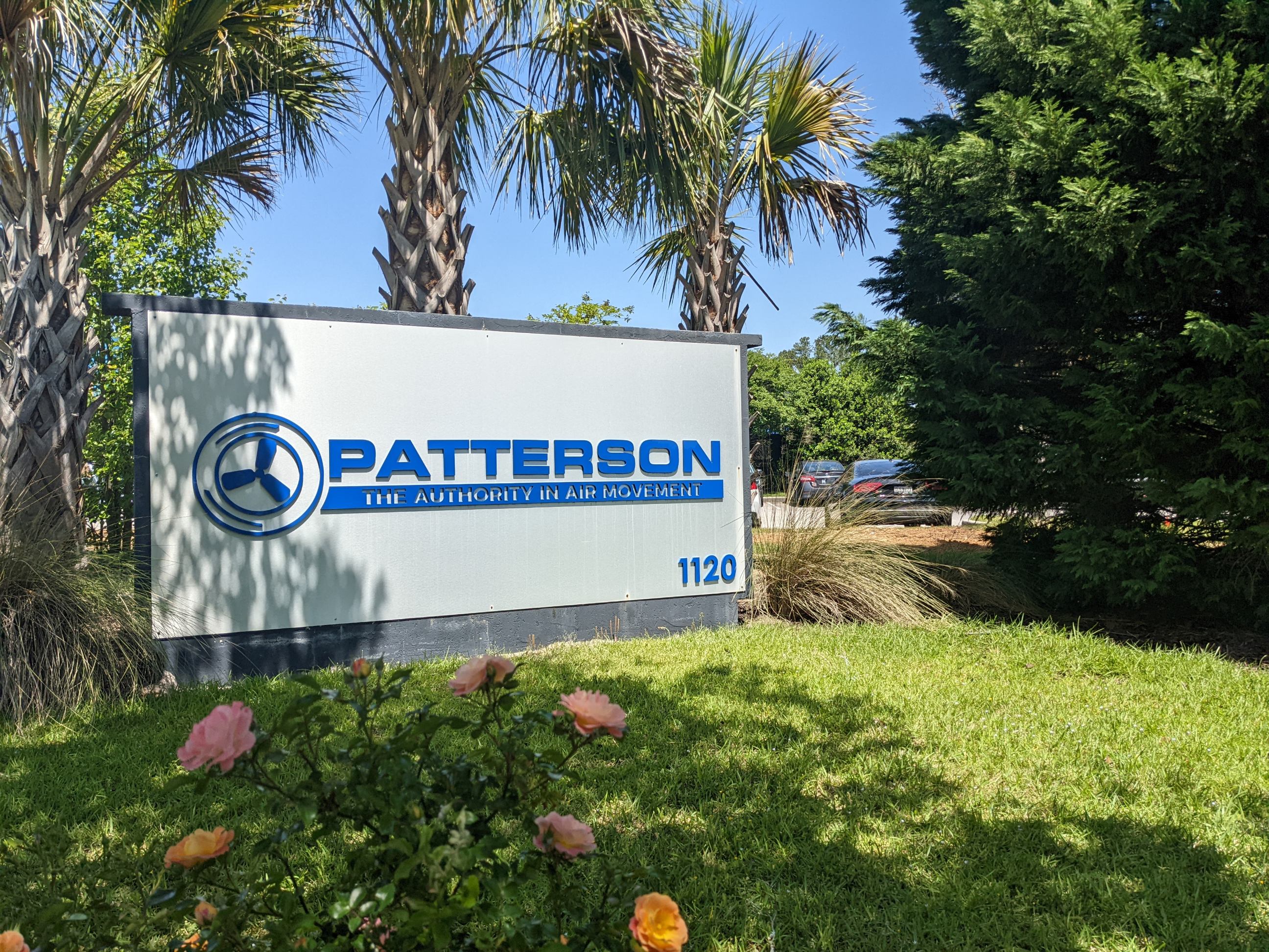 Patterson company sign in front of the headquarters, surrounded by palm trees and landscaping