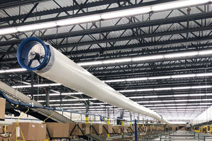 Industrial Patterson blower fan connected to fabric ducting for targeted air movement in a manufacturing facility