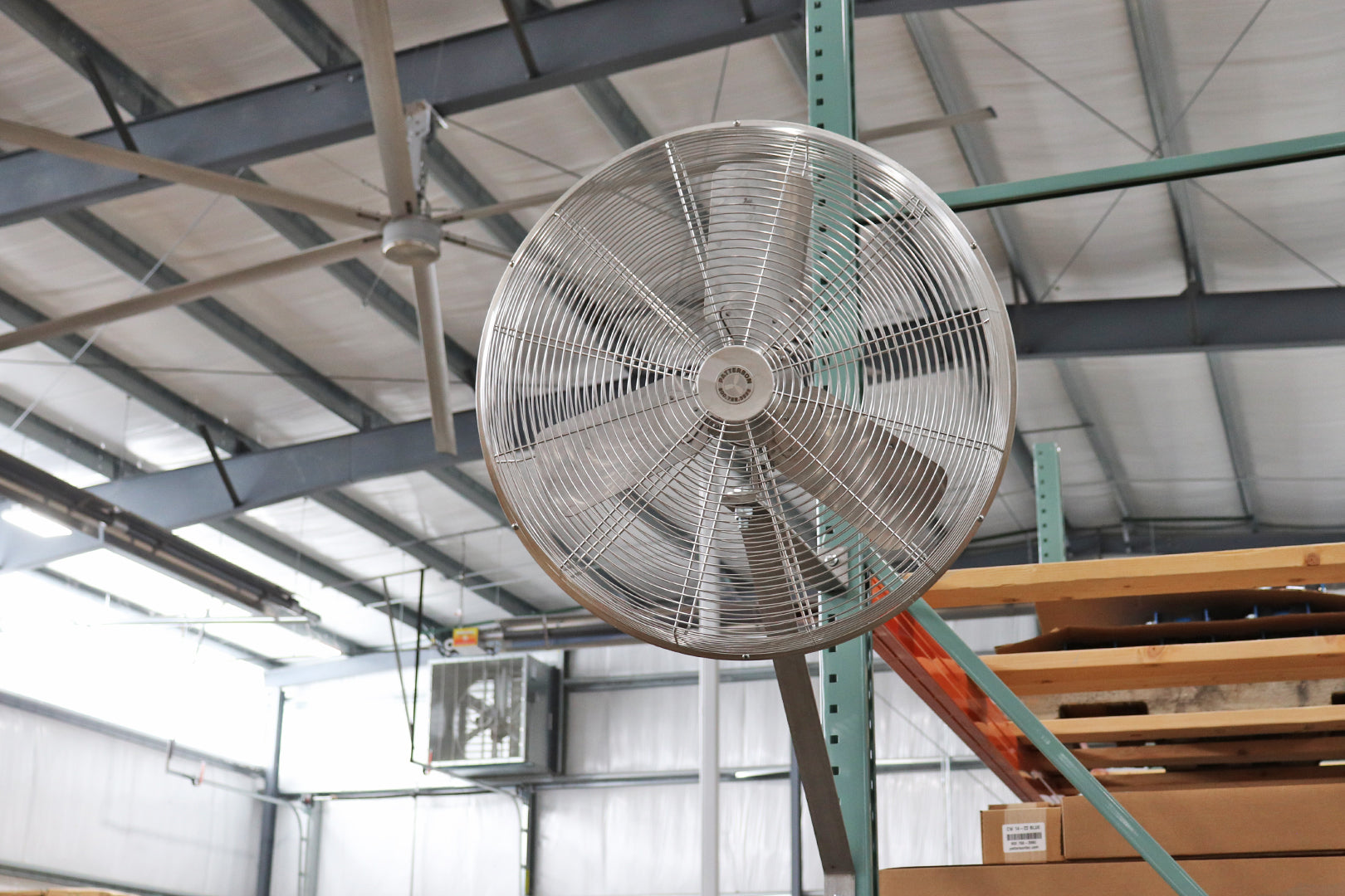 Industrial oscillating stainless fan mounted to steel shelving for improved airflow