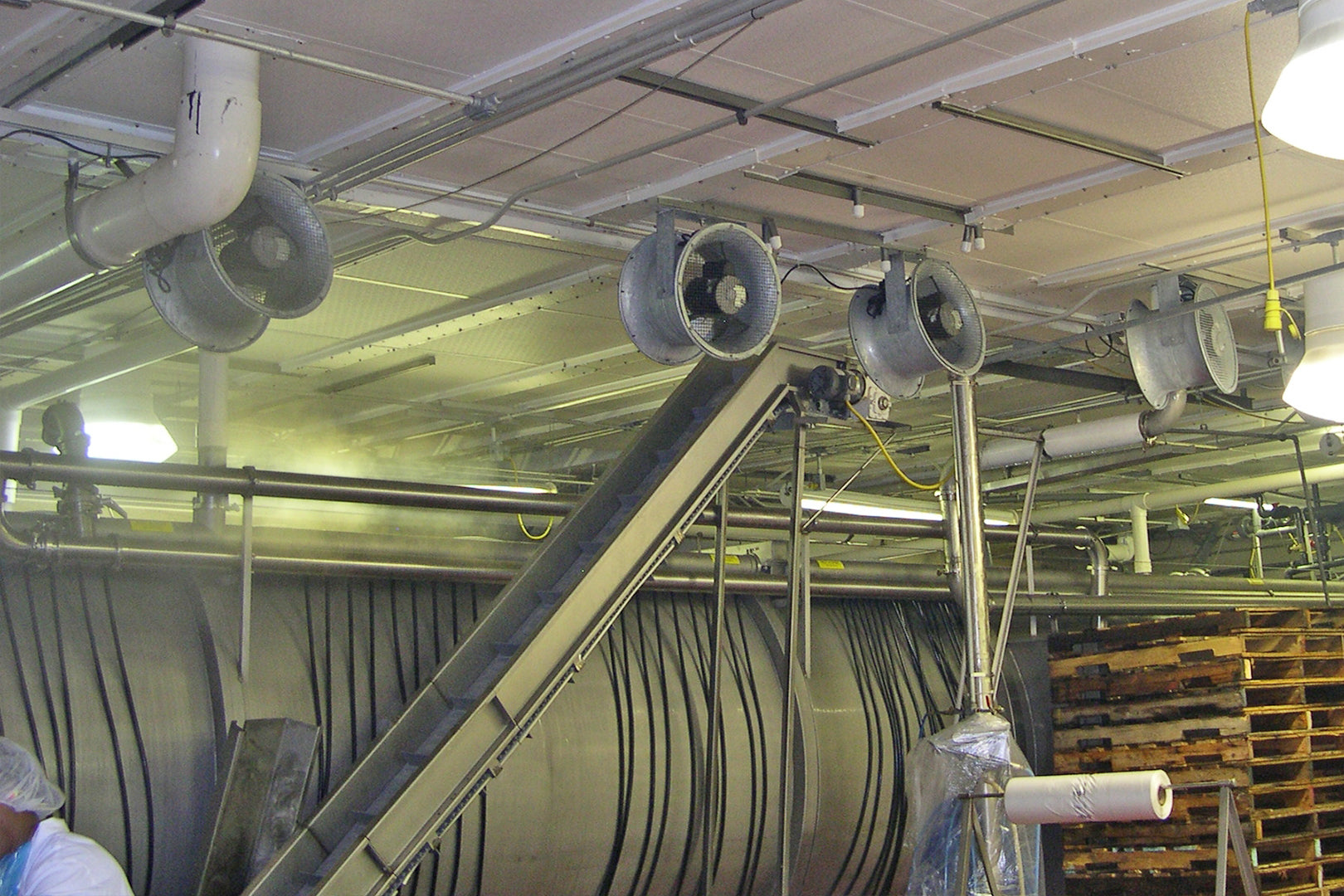 Industrial processing facility with multiple Patterson axial fans mounted on the ceiling for ventilation