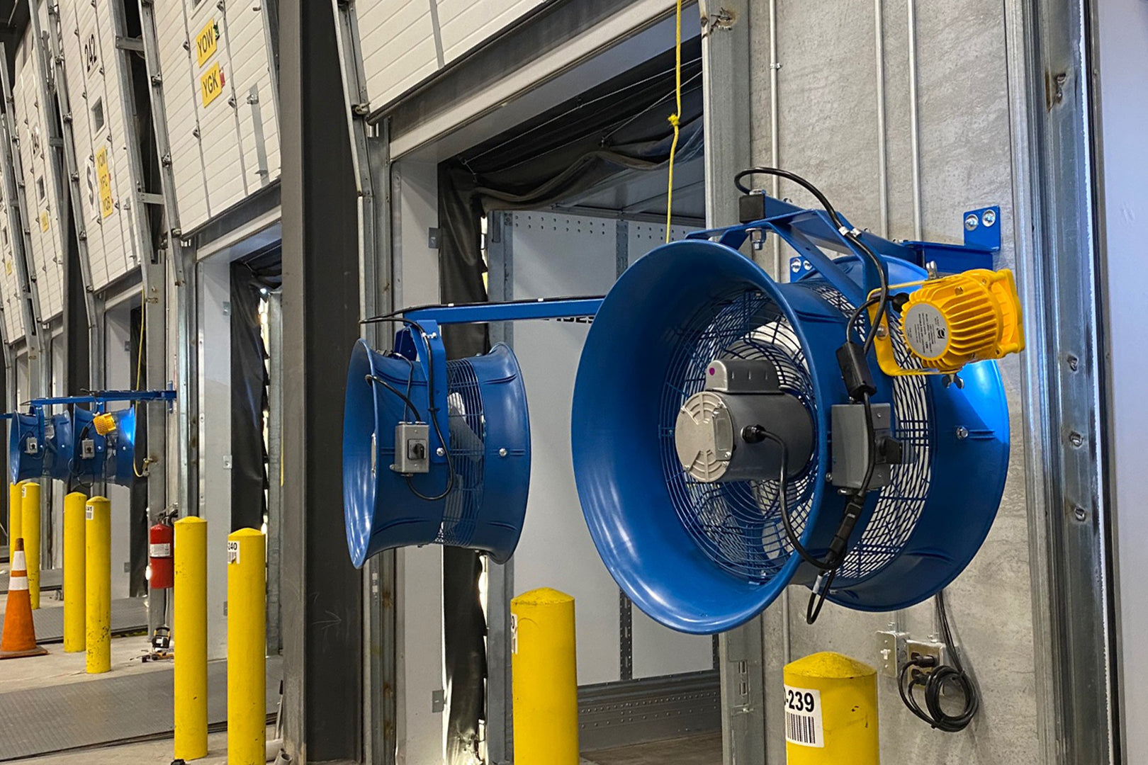 Patterson industrial dock fans mounted along warehouse loading bar doors