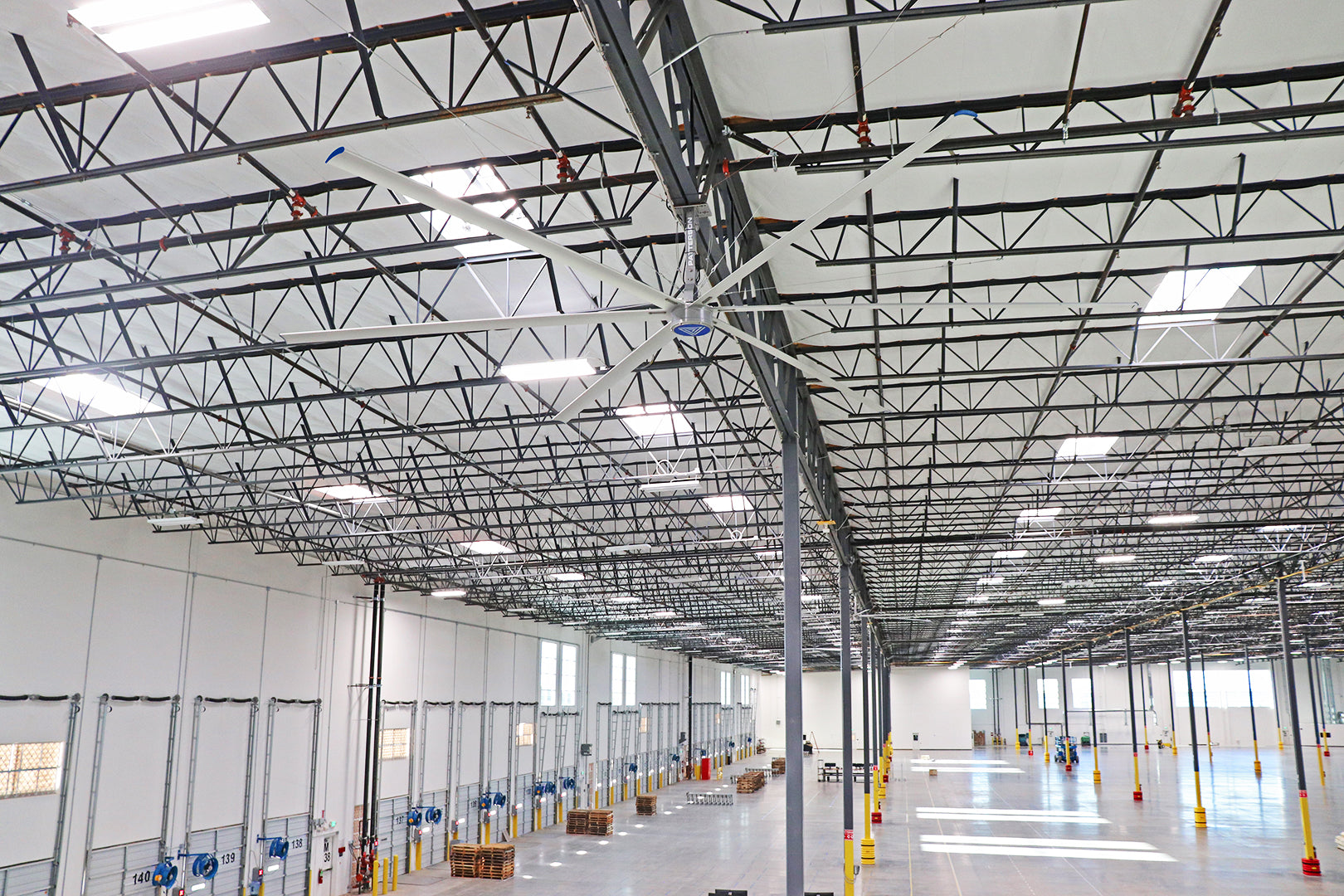 Large V-Series Patterson Fan installed in a spacious industrial warehouse to improve airflow and climate control