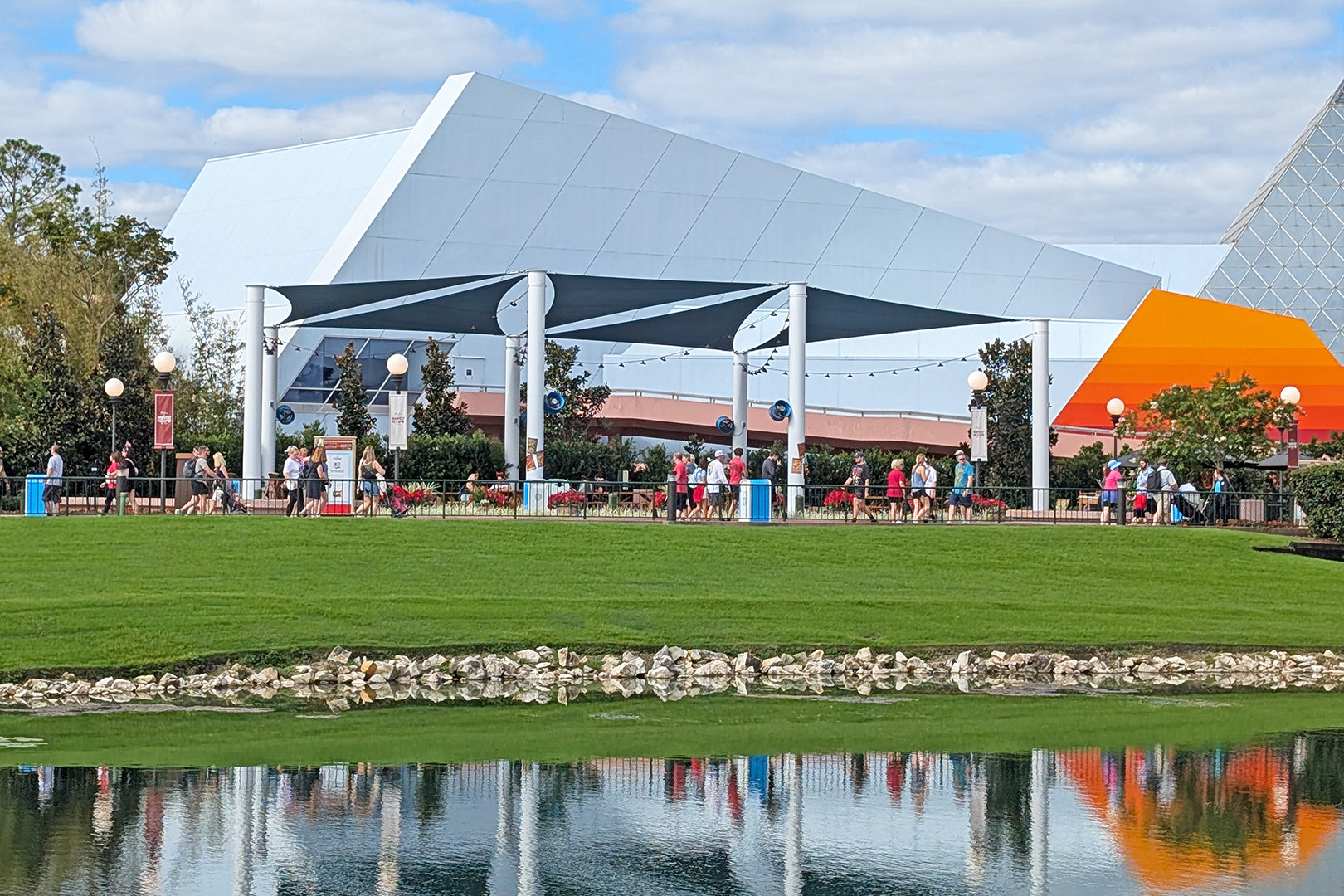 Patterson industrial fans mounted under an outdoor shade structure to cool visitors in a theme park space