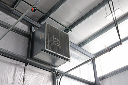 Industrial warehouse ventilation fan mounted near the ceiling 